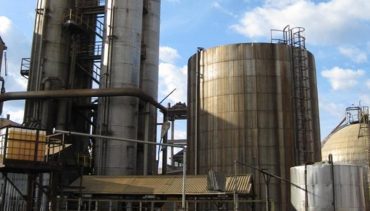 Gaseous ammonia, which comes from the plant 180 at a pressure of about 2.5 bar and temperature of about -14 ° C is liquefied in the compressors and stored in the SR-1 with liquid ammonia, which comes directly from plant 180. Nitric acid is produced by first mixing ammonia and air in a tank. In the presence of a catalyst, a reaction occurs which converts the ammonia to nitric oxide at plant 200. The nitric oxide is further reacted in the presence of water to produce 56% nitric acid.
